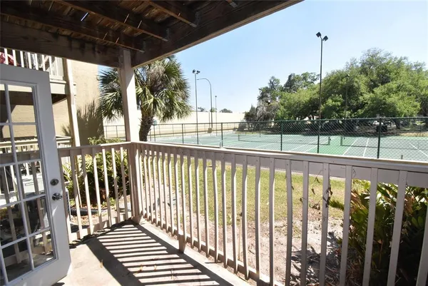 a view of a balcony with wooden floor