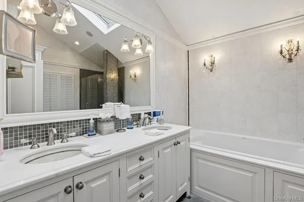 a bathroom with a sink a toilet and mirror
