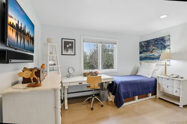 a bedroom with a bed and a large window