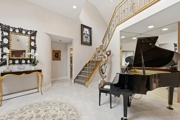a living room with furniture fireplace and a large window