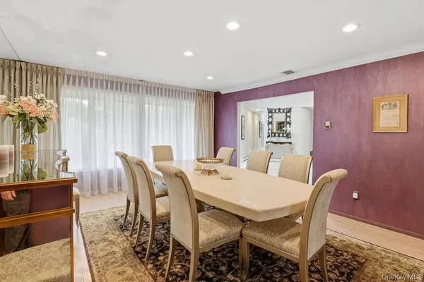 a dining room with furniture and a potted plant