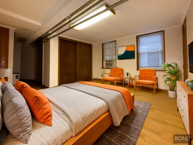 a bedroom with bed and a couch