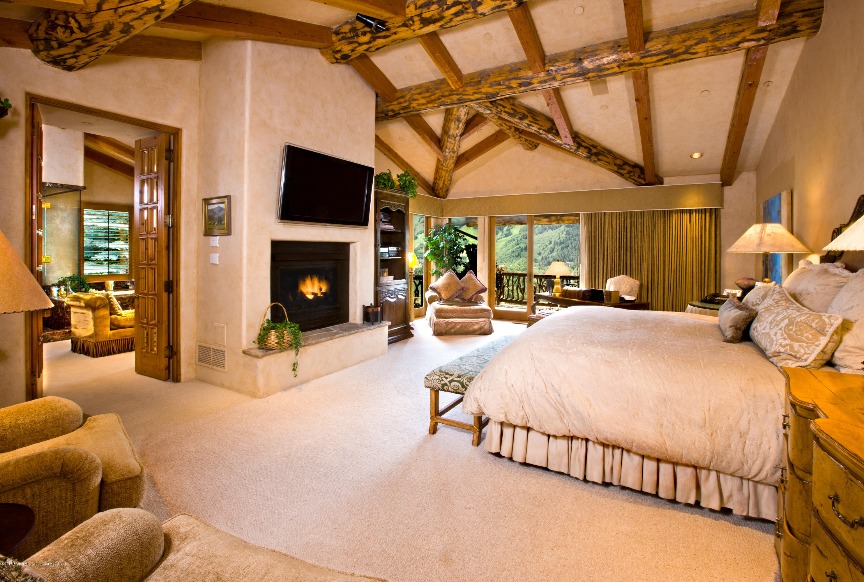 10 Ridge Place Aspen, CO 81612 - Photo 14 of 37 a bed room with a bed and a fireplace