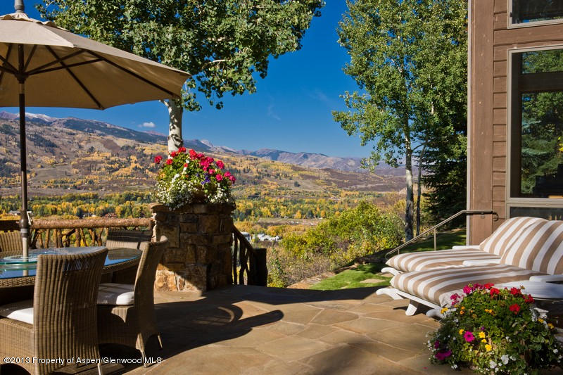 10 Ridge Place Aspen, CO 81612 - Photo 24 of 37 a view of a patio with a table and chairs under an umbrella