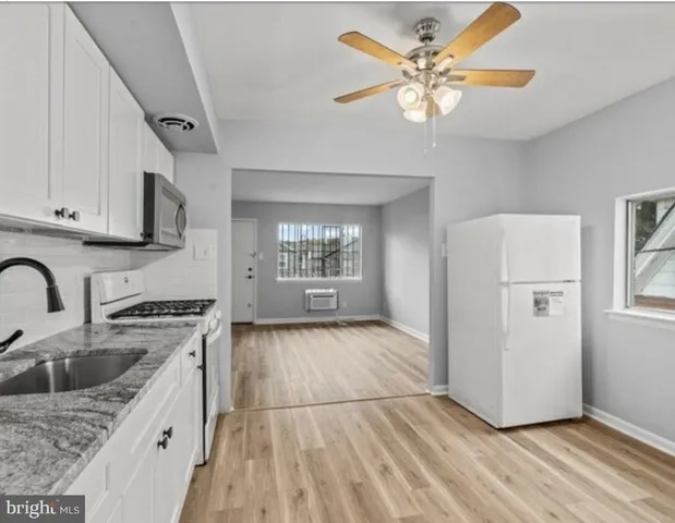 a kitchen with a stove a sink and a refrigerator