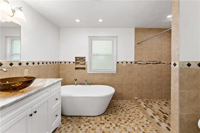a bathroom with a bathtub and shower