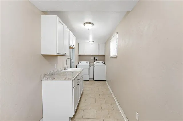 a kitchen with a sink a stove and cabinets