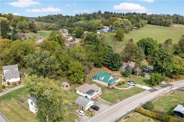 an aerial view of a house with a yard