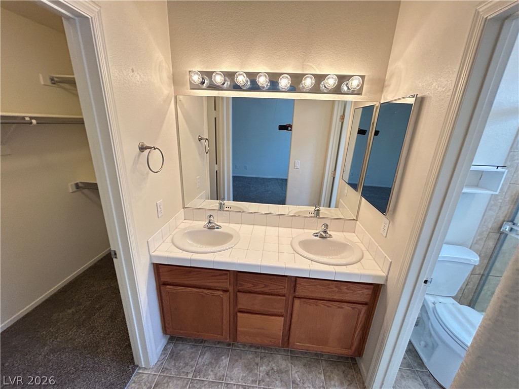1840 Montvale Las Vegas, NV 89134 - Photo 25 of 31 Double vanity in this primary bathroom offers ample counter space for daily routines.