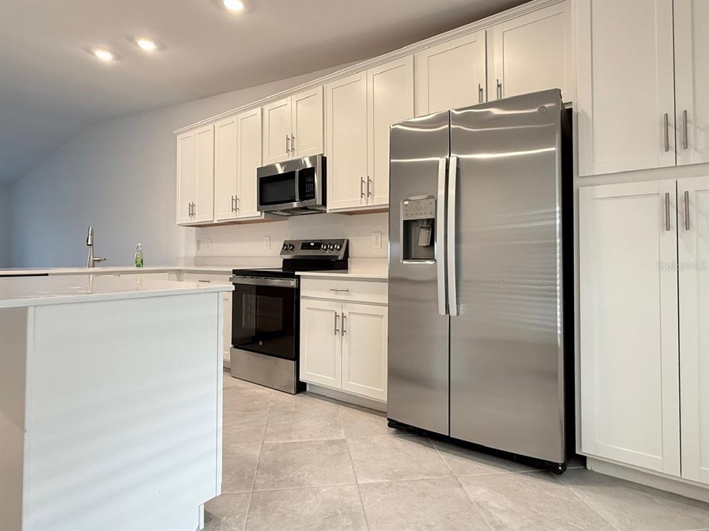 14261 Heritage Landing Boulevard, Unit 1621 Punta Gorda, FL 33955 - Photo 12 of 55 a kitchen with a refrigerator sink and microwave