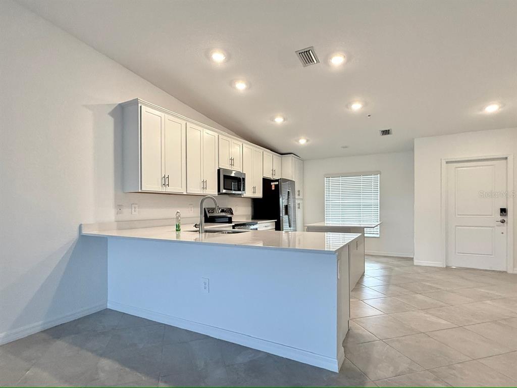 14261 Heritage Landing Boulevard, Unit 1621 Punta Gorda, FL 33955 - Photo 17 of 55 a large kitchen with stainless steel appliances lots of counter top space