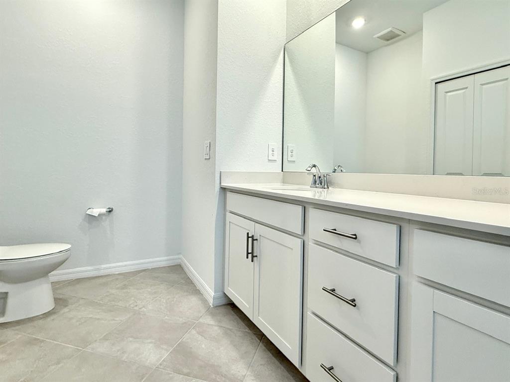 14261 Heritage Landing Boulevard, Unit 1621 Punta Gorda, FL 33955 - Photo 21 of 55 a bathroom with a toilet sink and mirror