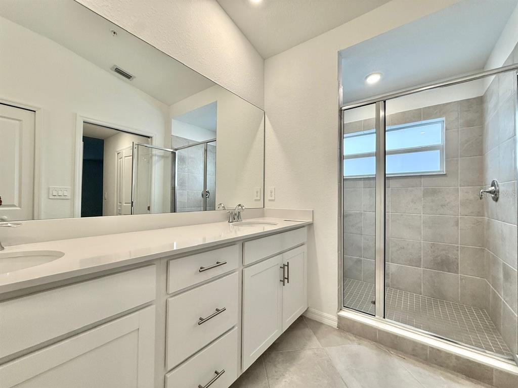 14261 Heritage Landing Boulevard, Unit 1621 Punta Gorda, FL 33955 - Photo 24 of 55 a spacious bathroom with a shower sink and mirror