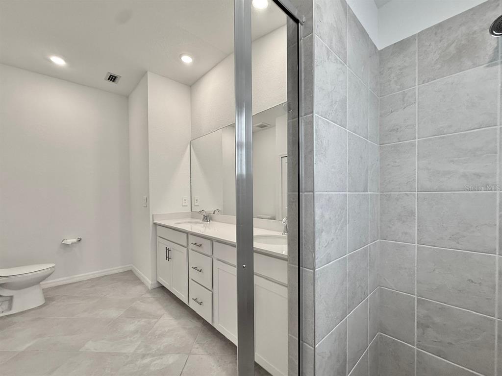 14261 Heritage Landing Boulevard, Unit 1621 Punta Gorda, FL 33955 - Photo 25 of 55 a spacious bathroom with a granite countertop sink a toilet and shower