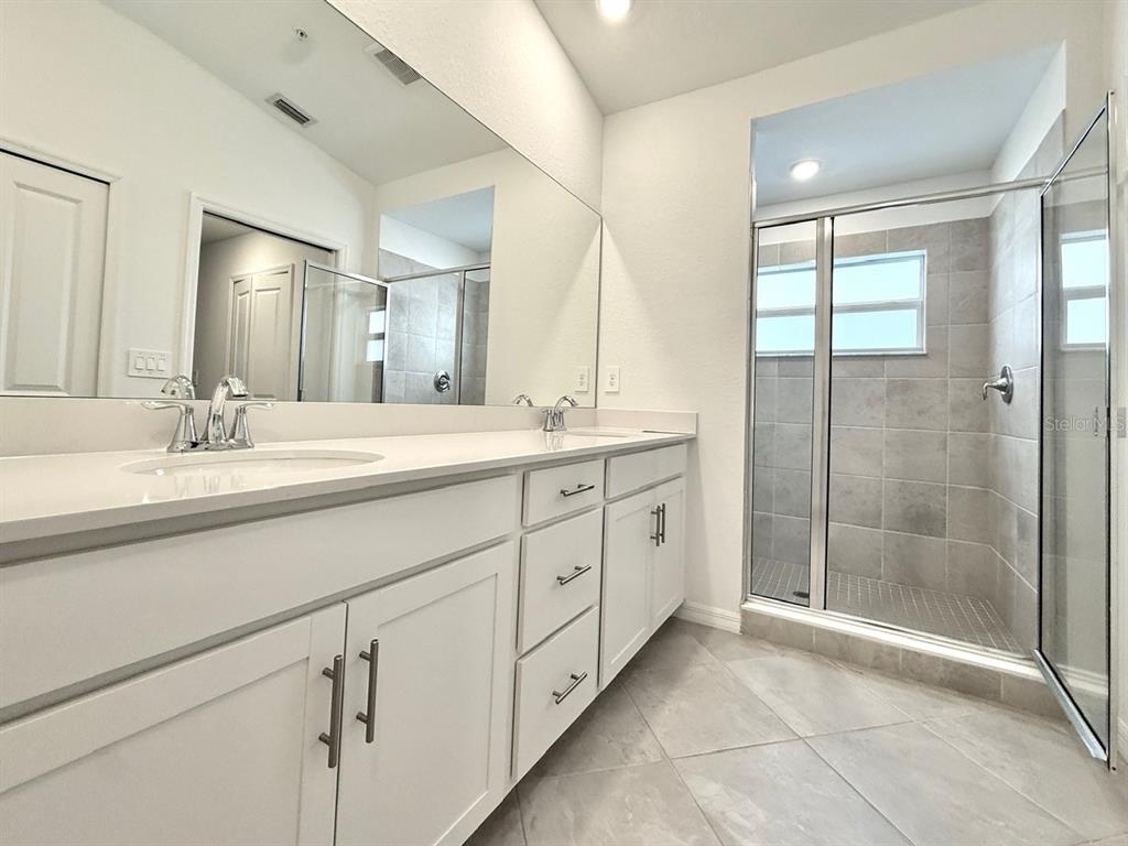 14261 Heritage Landing Boulevard, Unit 1621 Punta Gorda, FL 33955 - Photo 28 of 55 a spacious bathroom with double sink shower and a mirror