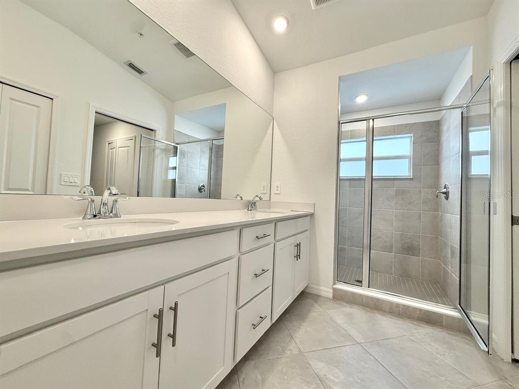 14261 Heritage Landing Boulevard, Unit 1621 Punta Gorda, FL 33955 - Photo 29 of 55 a bathroom with double sink and a mirror
