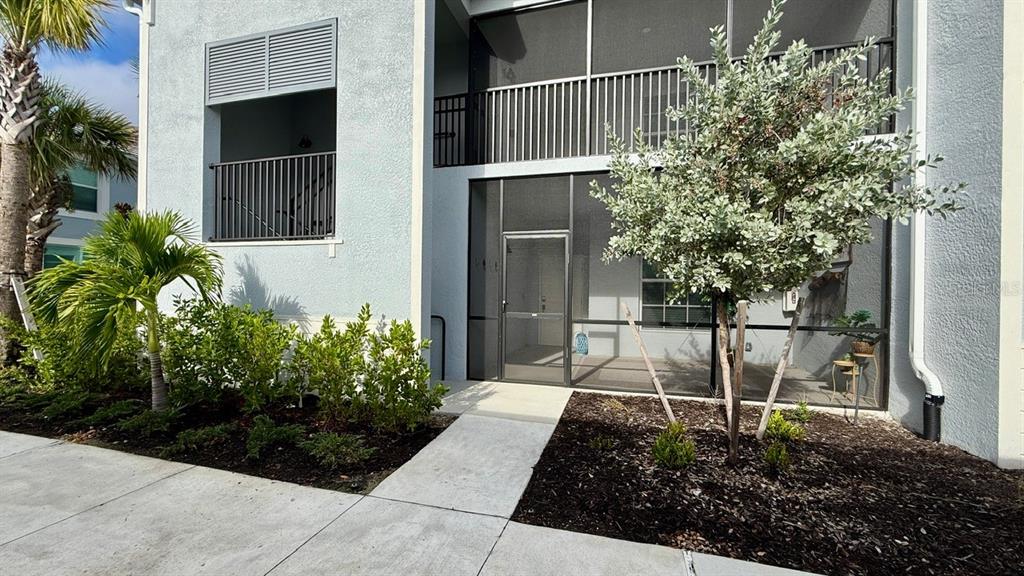 14261 Heritage Landing Boulevard, Unit 1621 Punta Gorda, FL 33955 - Photo 4 of 55 a view of a kid door with flower garden