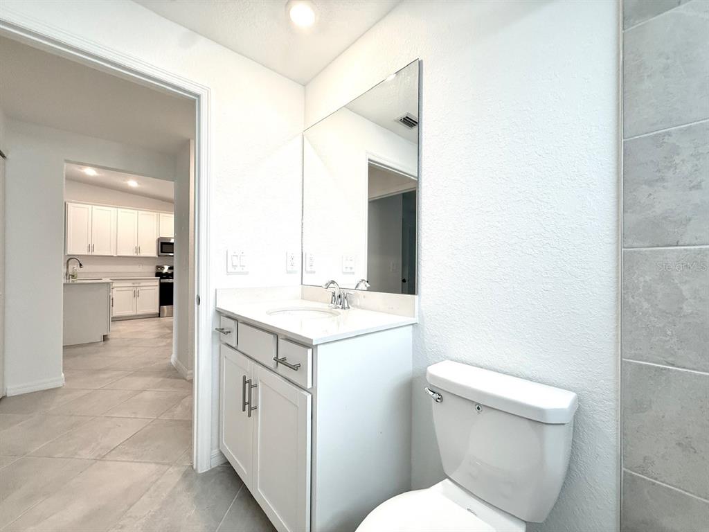 14261 Heritage Landing Boulevard, Unit 1621 Punta Gorda, FL 33955 - Photo 43 of 55 a spacious bathroom with a toilet sink and mirror