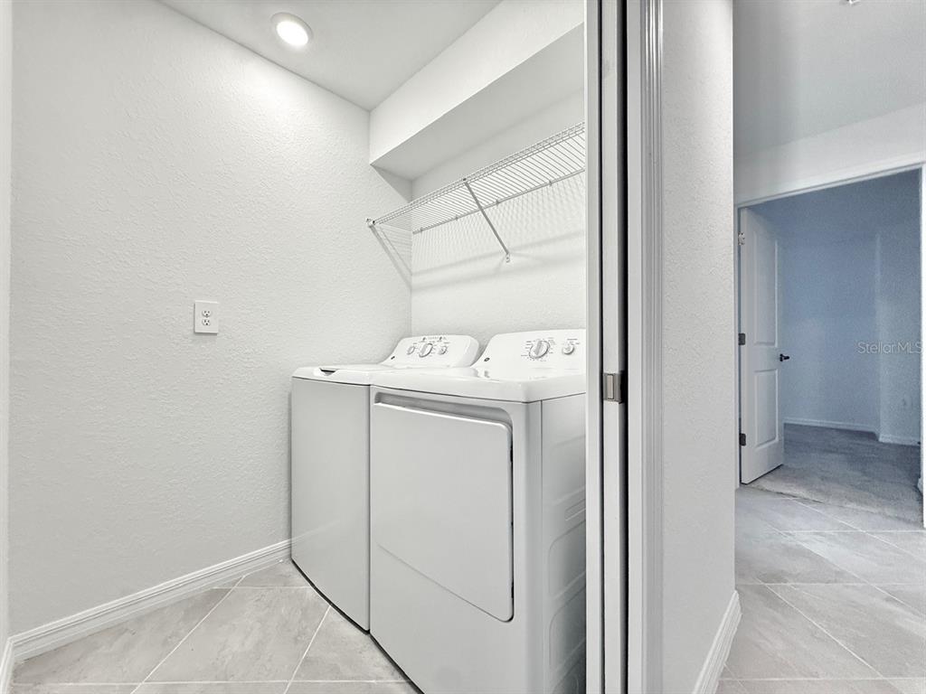 14261 Heritage Landing Boulevard, Unit 1621 Punta Gorda, FL 33955 - Photo 44 of 55 a utility room with dryer and washer