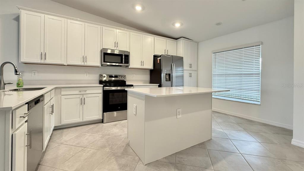14261 Heritage Landing Boulevard, Unit 1621 Punta Gorda, FL 33955 - Photo 9 of 55 a kitchen with a sink a stove and refrigerator