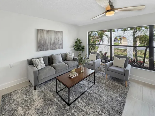 a living room with furniture and a large window