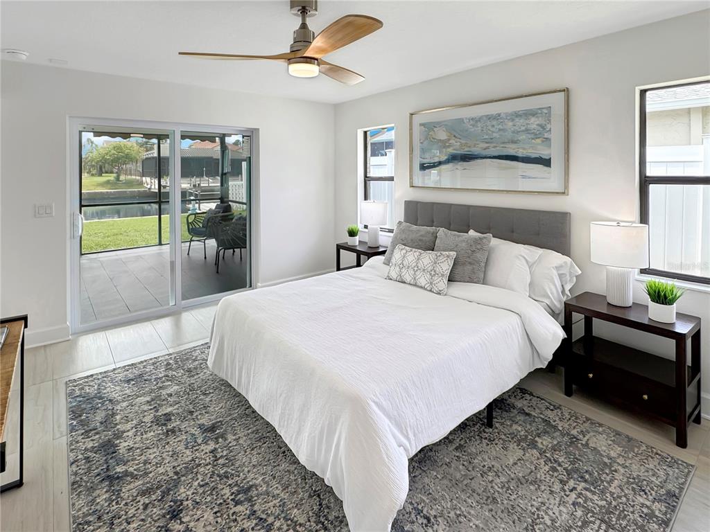 Undisclosed Address Port Richey, FL 34668 - Photo 14 of 44 a large bed sitting in a bedroom next to a window