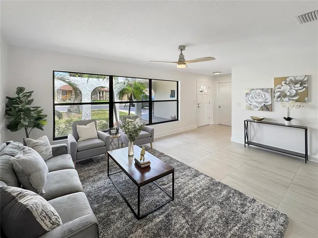 a living room with furniture and a large window
