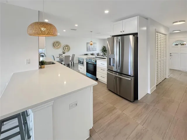 a kitchen with kitchen island a counter space and stainless steel appliances