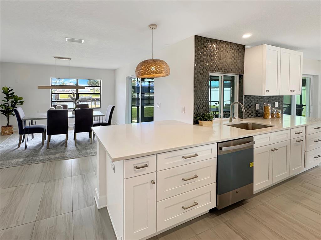 Undisclosed Address Port Richey, FL 34668 - Photo 20 of 44 a kitchen with white cabinets and sink