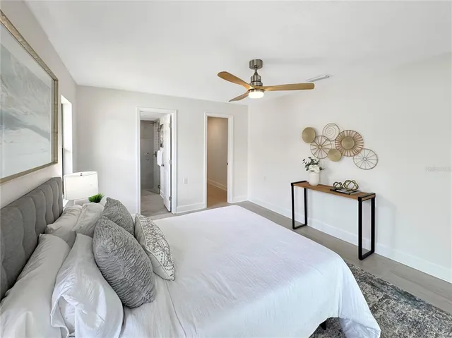 a bedroom with a bed dresser and a window