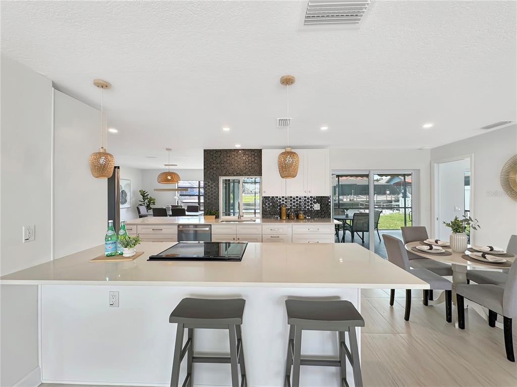 Undisclosed Address Port Richey, FL 34668 - Photo 22 of 44 a dining room with kitchen island a table and chairs