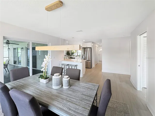 a dining room with furniture and wooden floor