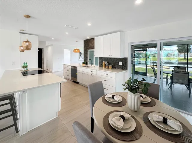 a kitchen with a table and chairs in it