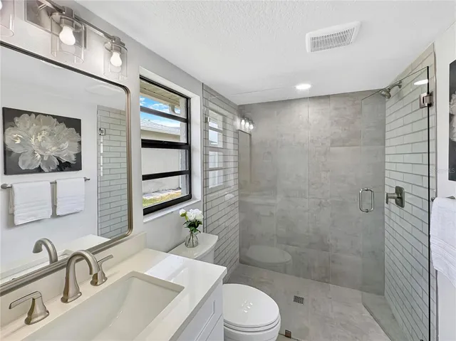a bathroom with a sink toilet and shower