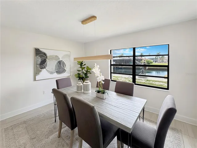 a dining room with furniture and window