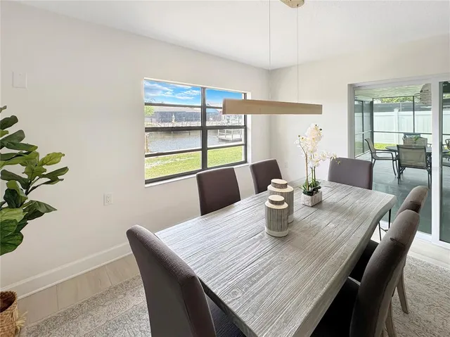a dining room with furniture and wooden floor