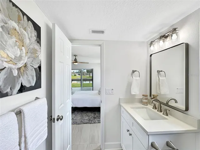 a en suite bathroom with double vanity sink and a mirror