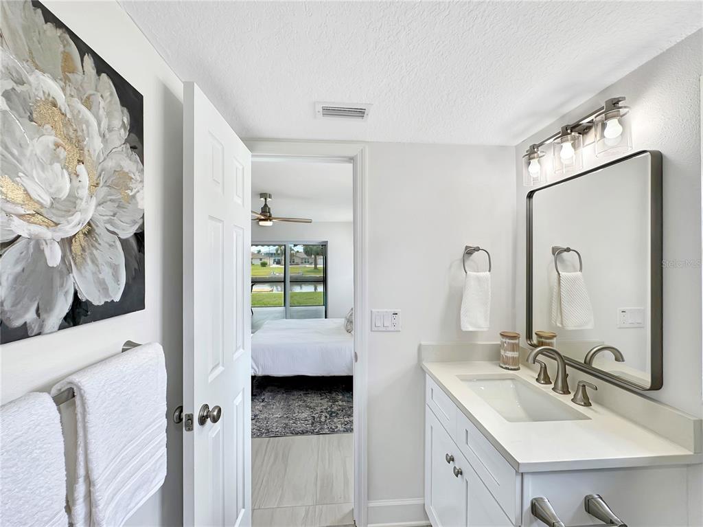 Undisclosed Address Port Richey, FL 34668 - Photo 32 of 44 a en suite bathroom with double vanity sink and a mirror