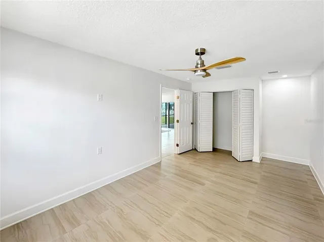 a view of a livingroom with a ceiling fan and wooden floor