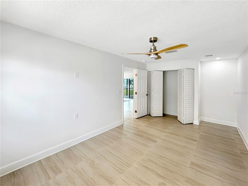 Undisclosed Address Port Richey, FL 34668 - Photo 37 of 44 a view of a livingroom with a ceiling fan and wooden floor