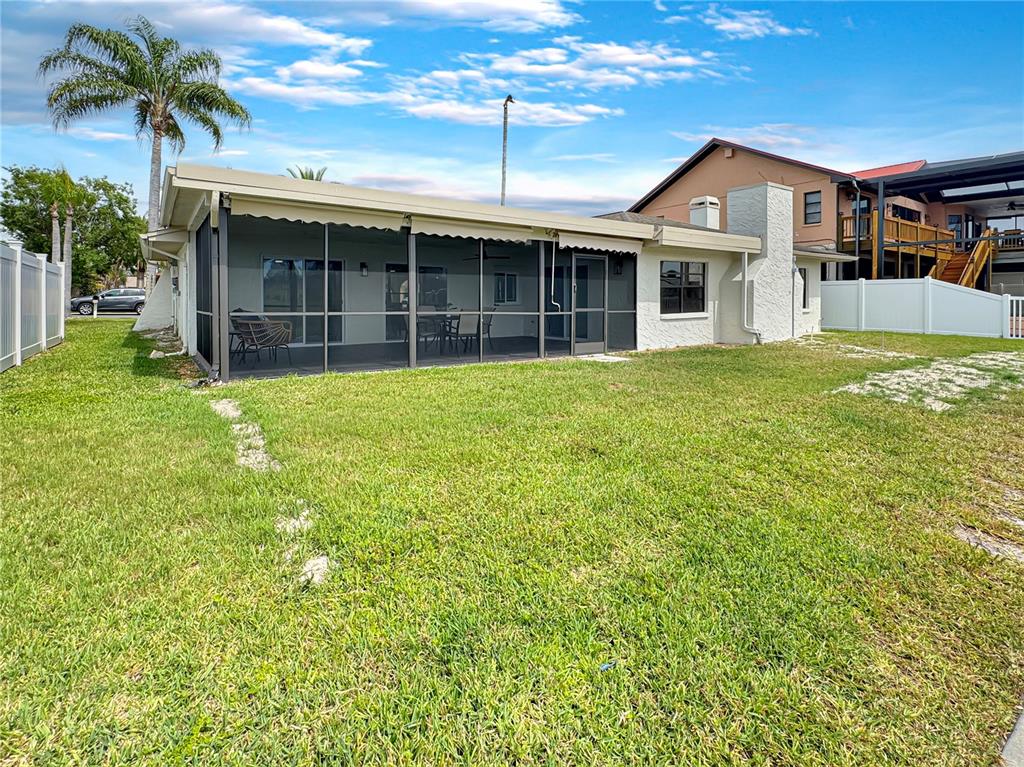 Undisclosed Address Port Richey, FL 34668 - Photo 39 of 44 a front view of a house with a garden