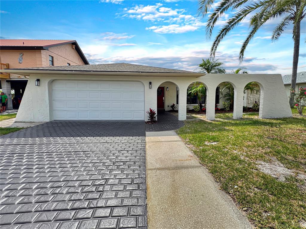 Undisclosed Address Port Richey, FL 34668 - Photo 43 of 44 a view of a grey house with a yard