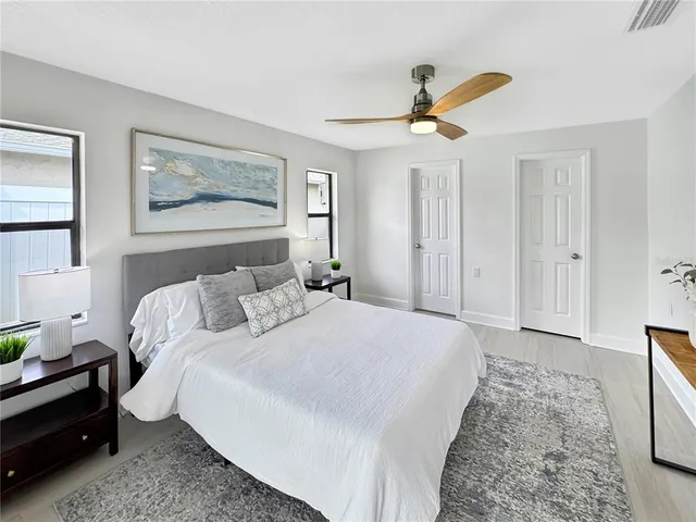 a bedroom with a bed and a chandelier