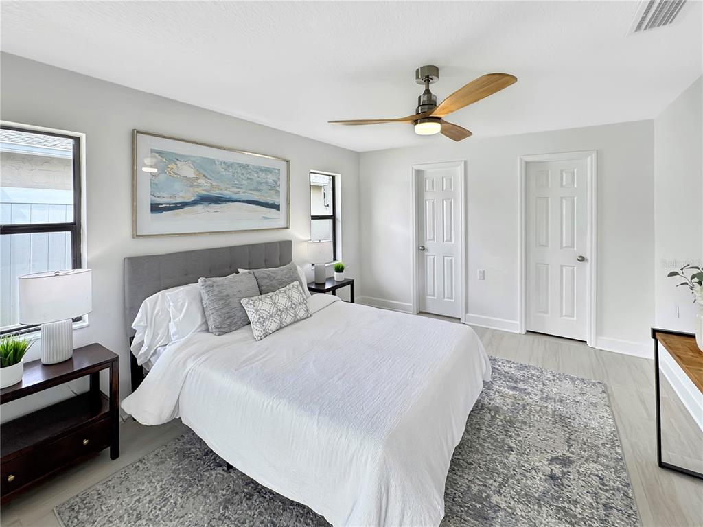 Undisclosed Address Port Richey, FL 34668 - Photo 5 of 44 a bedroom with a bed and a chandelier