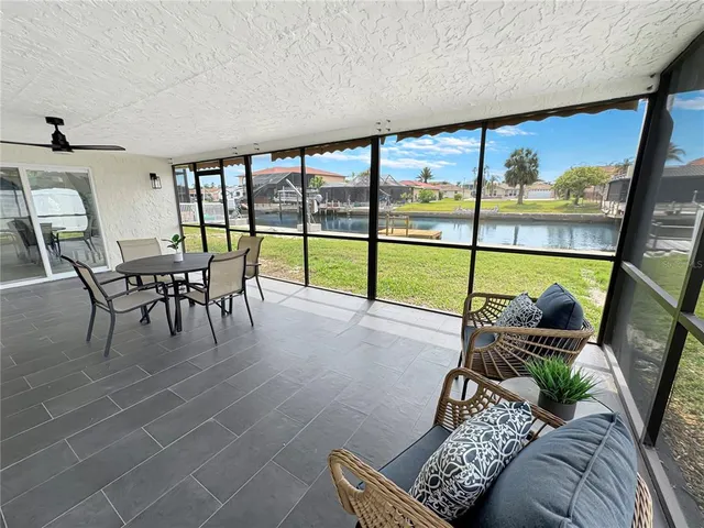 a living room with furniture and a floor to ceiling window