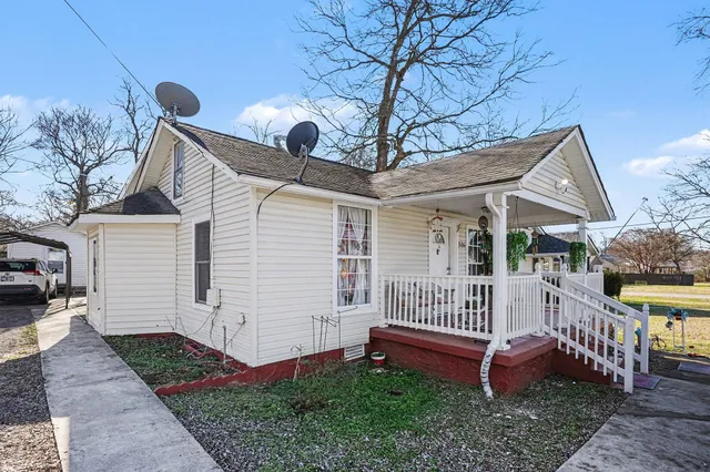 a front view of a house with garden and deck