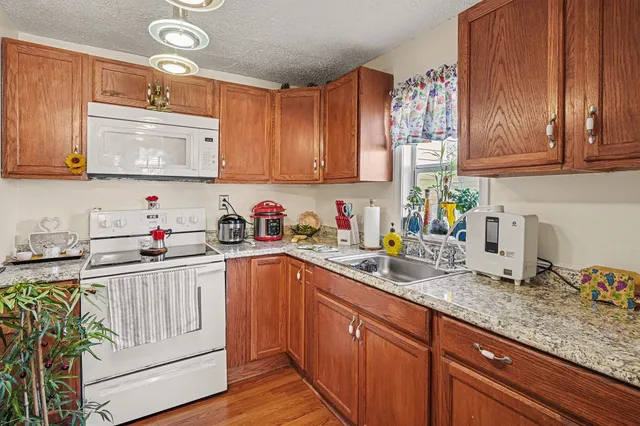 a bathroom with a sink a toilet and shower curtain
