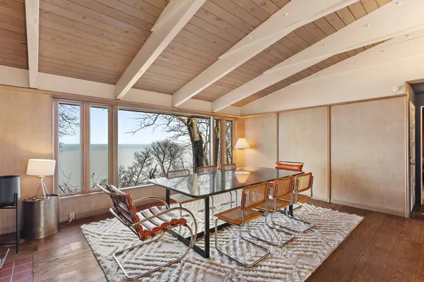 a view of a livingroom with wooden floor and entryway