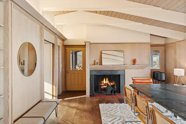 a living room with fireplace furniture and a rug