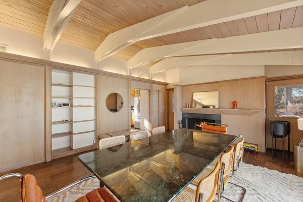 a living room with couch chairs and wooden floor